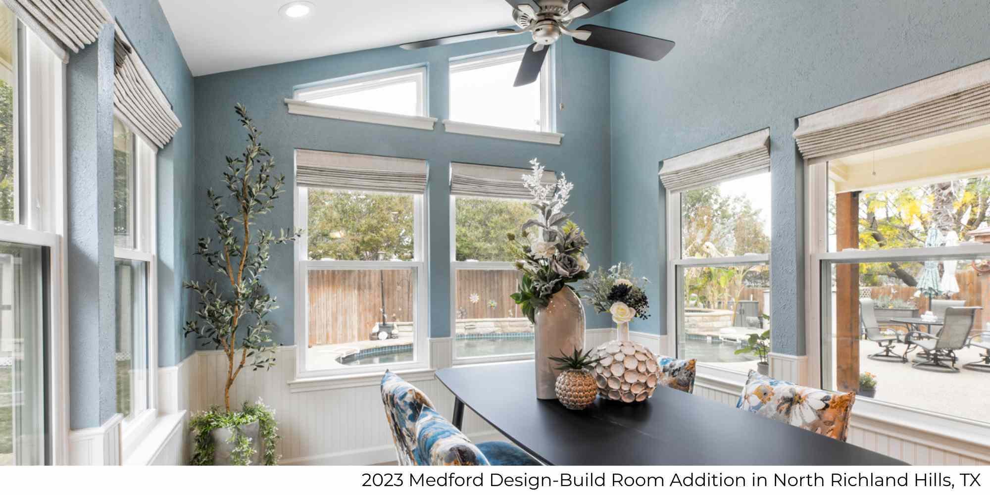 A dining room addition as part of a whole home remodel with lots of windows and a view of a pool by Medford Design-Build