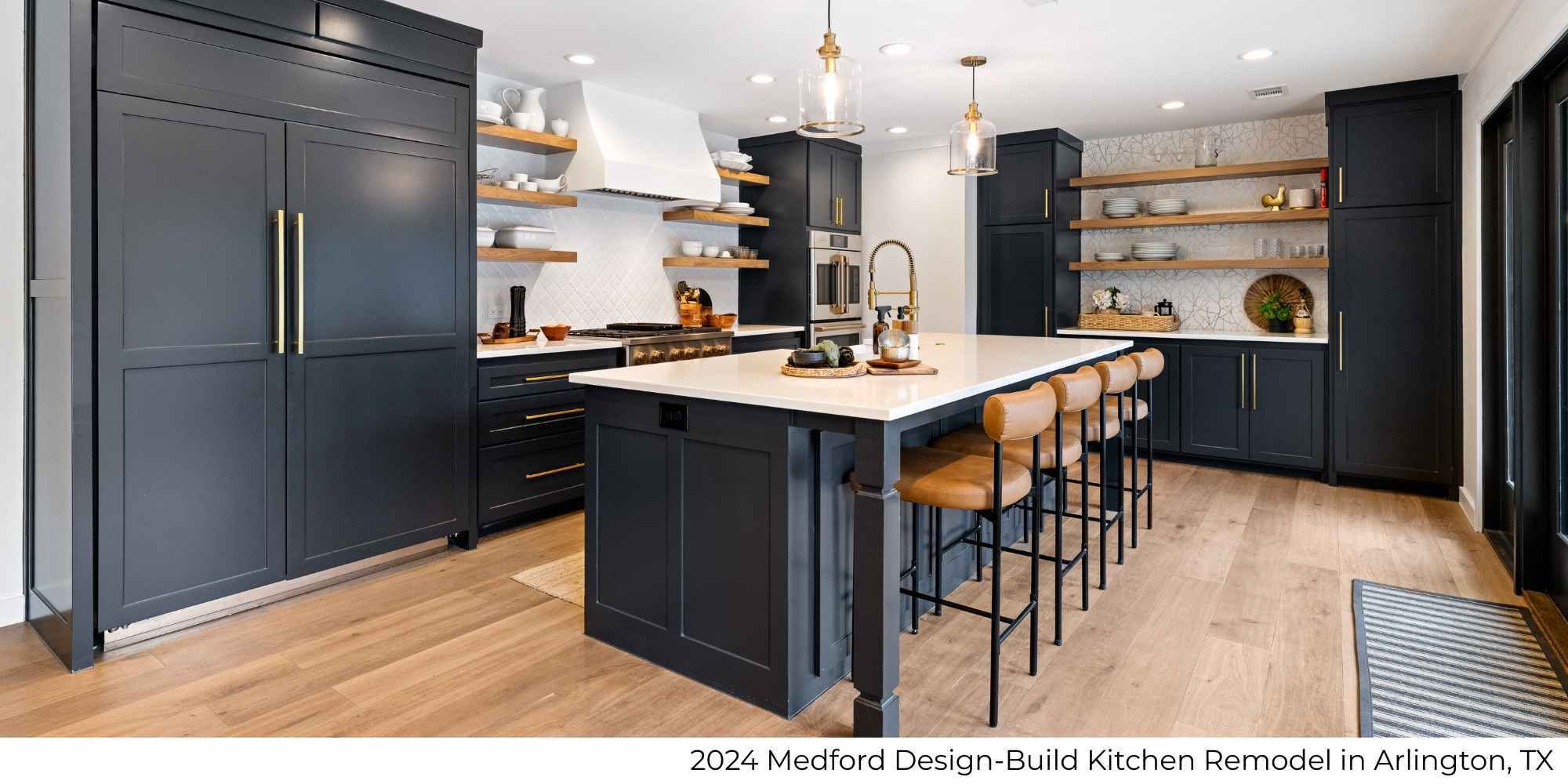 A kitchen remodel featuring a large island with seating, navy blue cabinetry, and a white tile backsplash by Medford Design-Build