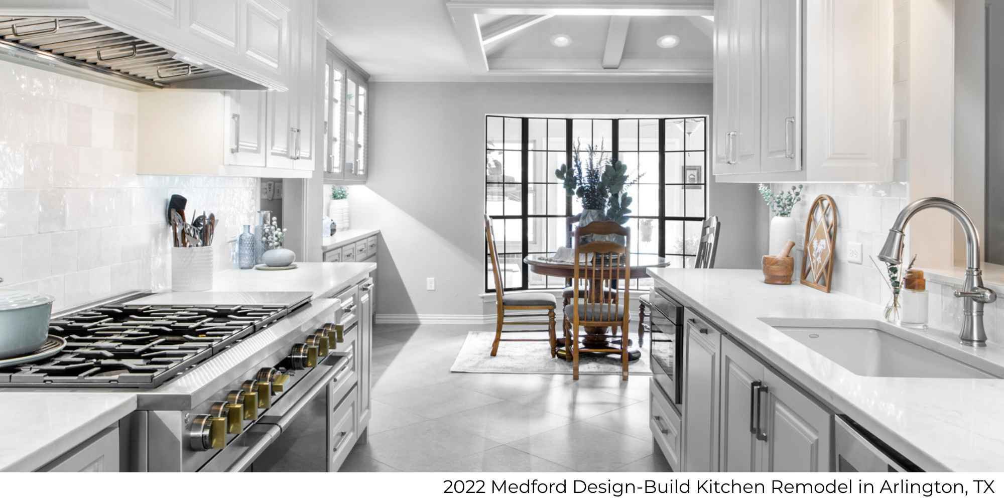 A kitchen remodel with white and light gray tones and a dining area by Medford Design-Build