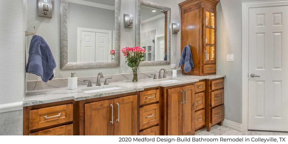 Image of bathroom remodel with dual wood vanity and marble countertops by Medford Design-Build in Colleyville, TX