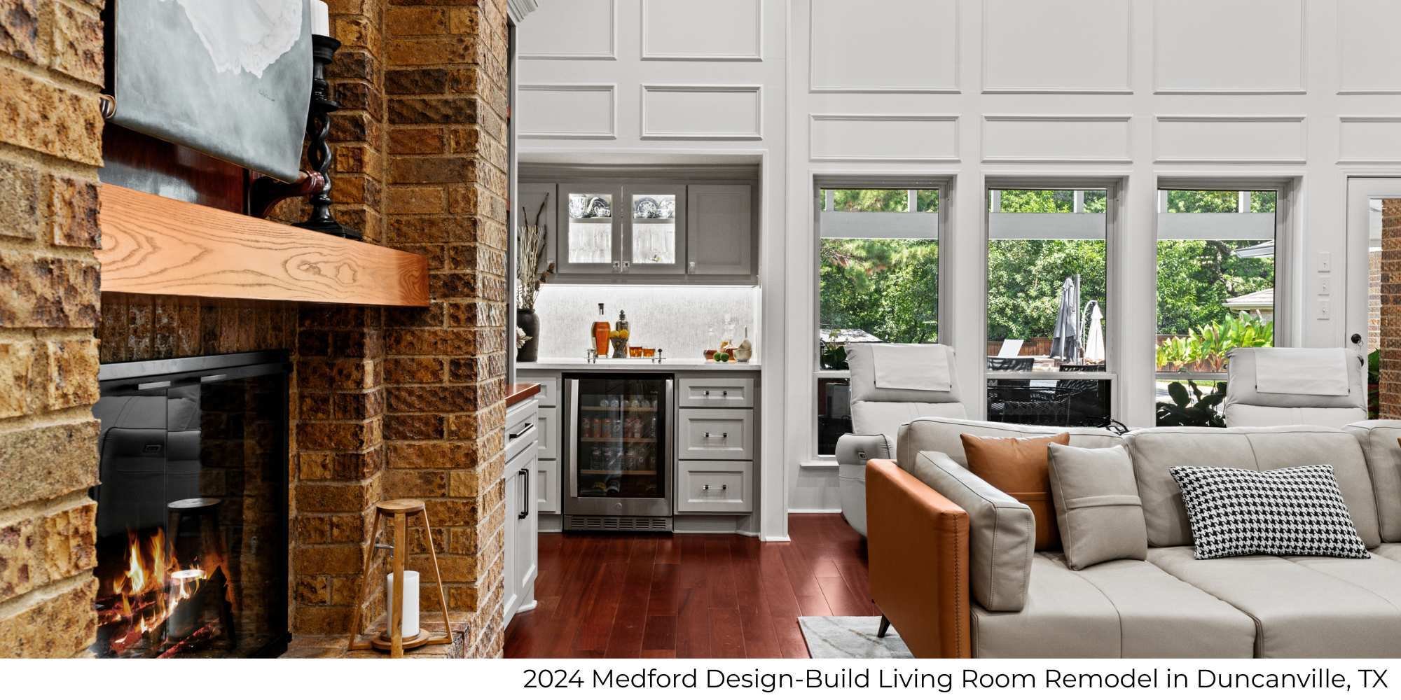 Image of a living room remodel with stone feature fireplace and bar by Medford Design-Build in Duncanville, TX