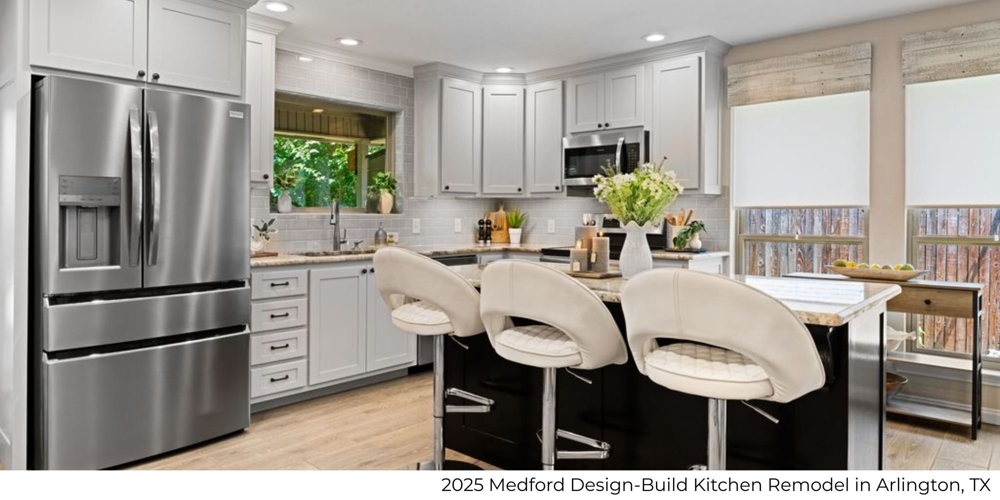 Kitchen remodel in Arlington, TX by Medford Design-Build featuring an island with seating, white cabinetry, and a full-height tile backsplash.
