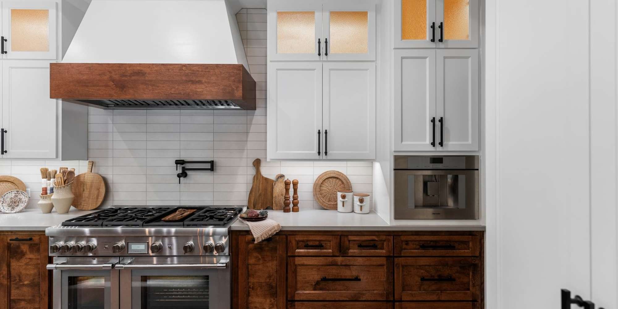 Warm wood cabinetry pairs with white tile and upper cabinets in this Tarrant County kitchen by Medford Design-Build