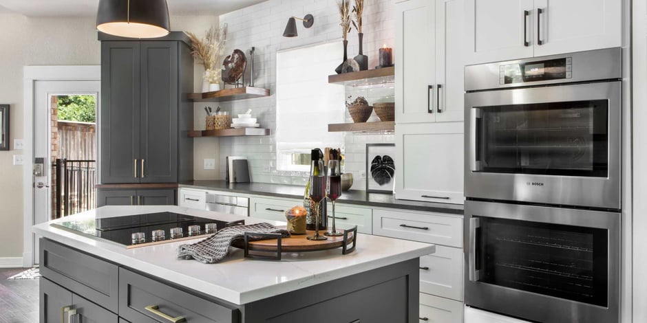 Kitchen remodel featuring an island with a stovetop built and built in ovens by Medord Design-Build