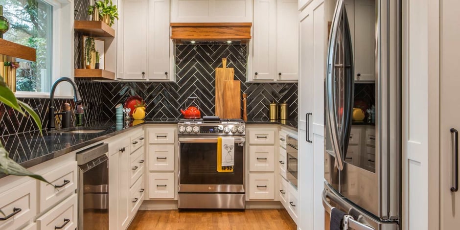 Kitchen remodel with black tile backsplash and wooden shelf features by Medford Design-Build