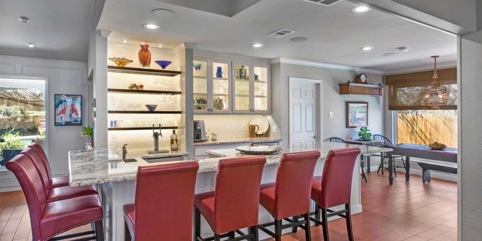 Stylish custom bar and dining space in a whole home remodel by Medford Design-Build