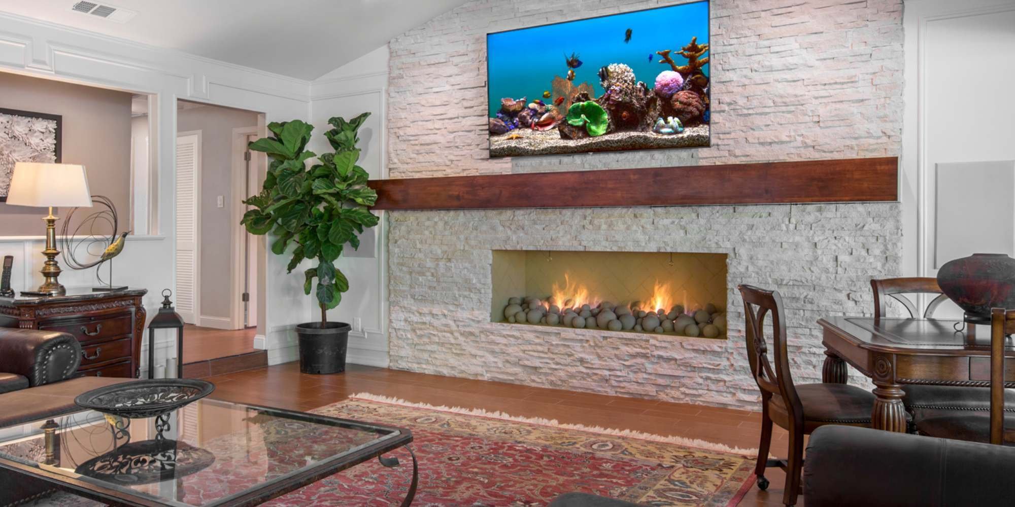 Transitional living room with gas fireplace and recessed lighting in a whole home remodel by MDB