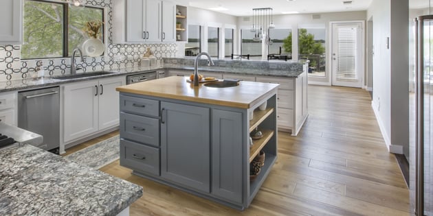 Kitchen remodel in Arlington, TX with wood floors, custom backsplash, and two-tone cabinets