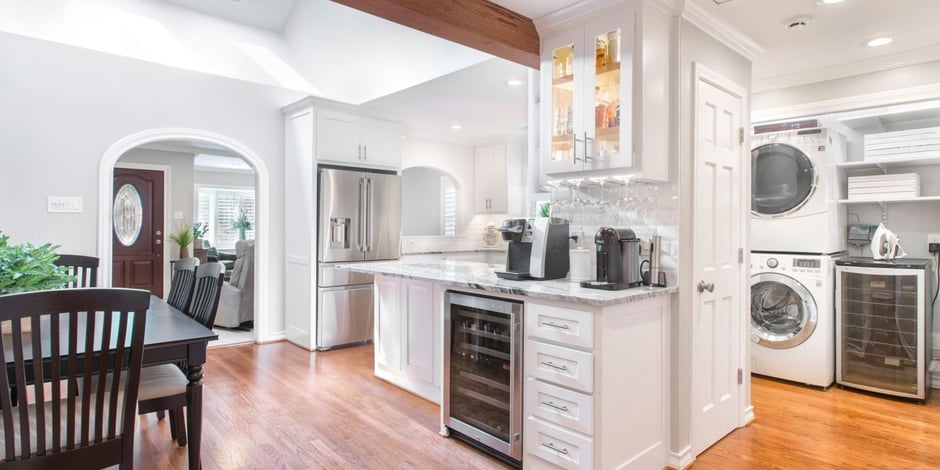 Medford Design-Build kitchen renovation in Arlington, TX featuring stacked washer-dryer and glass cabinets