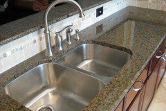 The remodeled kitchen turned out beautifully, complete with dark cherry stained cabinets, granite counters, stainless steel appliances, new backsplash tile, can lighting and flooring!