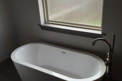 The oversized tub and surround were replaced by a simplistic free-standing tub, providing the clean, open look our clients had in mind.