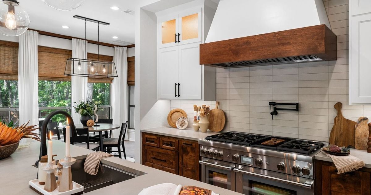 Stylish kitchen remodel in Arlington with two-tone cabinets and tile backsplash by Medford Design-Build