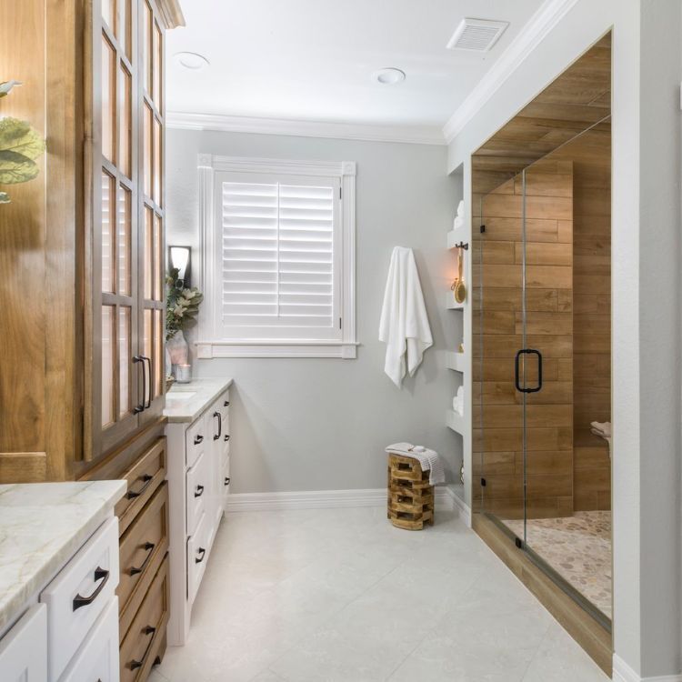 Bathroom remodel with wood-accented shower and custom cabinetry by Medford Design-Build